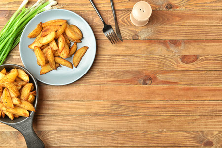Composition with tasty baked potato on wooden backgroundの写真素材