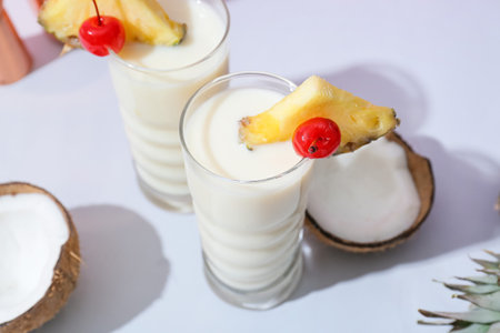 Glasses with tasty Pina Colada cocktail on color background