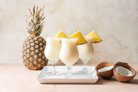 Glasses with tasty Pina Colada cocktail on light backgroundの写真素材
