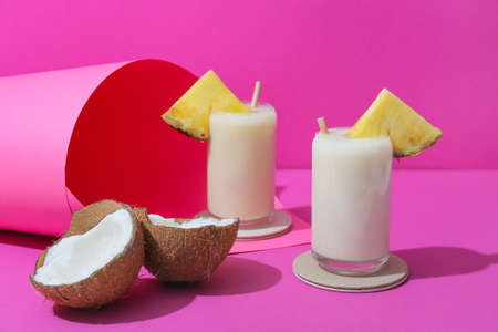 Glasses with tasty Pina Colada cocktail on color background