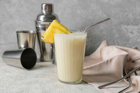 Glass with tasty Pina Colada cocktail on light backgroundの写真素材