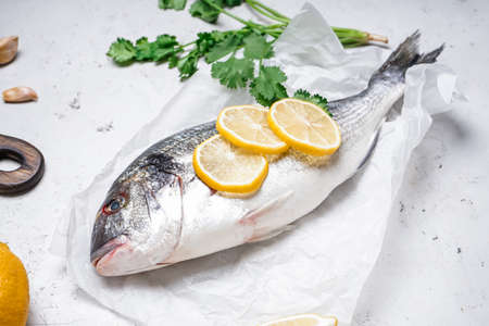 Raw dorado fish on light backgroundの写真素材