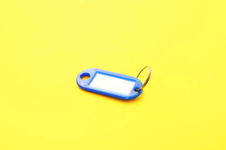 Plastic key tag on yellow backgroundの写真素材