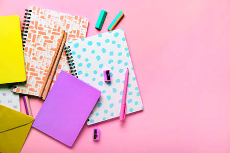 Notebooks and stationery supplies on color backgroundの写真素材