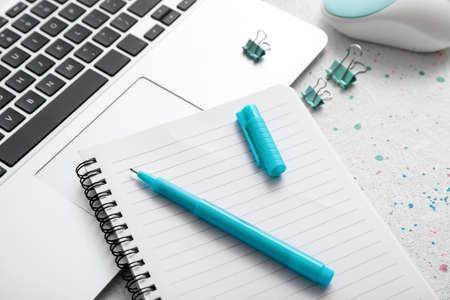 Notebook, pen and laptop on table, closeupの写真素材