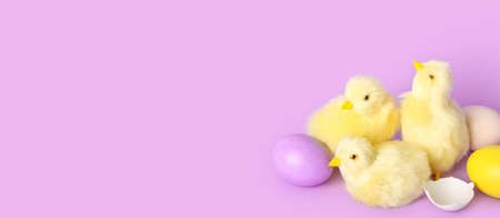 Cute chickens and Easter eggs on lilac background with space for text