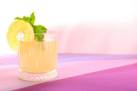 Glass of delicious mai tai cocktail on color background