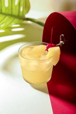 Glass of delicious mai tai cocktail on color background