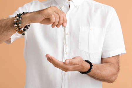 Mature man with pendulum on color backgroundの写真素材