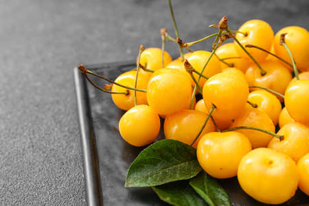 Tasty sweet cherry on gray background