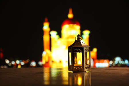 Beautiful Islamic lamp on table at night