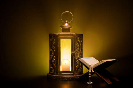 Islamic lamp with Quran on dark color backgroundの写真素材