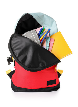 School backpack and stationery on white background