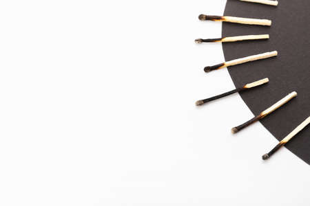 Burnt matches on white and black background. concept of work burnoutの写真素材