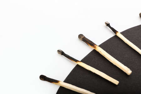 Burnt matches on white and black background, closeup. concept of work burnoutの写真素材