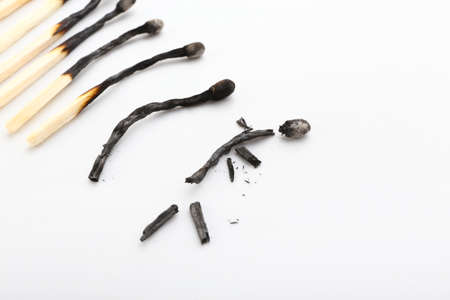 Burnt matches on white background, closeup. Different life stages conceptの写真素材