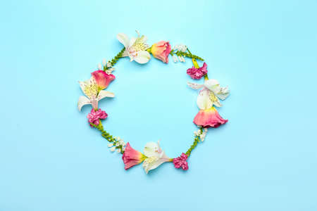 Frame made of beautiful flowers on blue backgroundの写真素材
