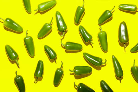 Green jalapeno peppers on color backgroundの写真素材