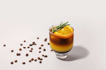 Glass of tasty coffee with orange juice on light backgroundの写真素材