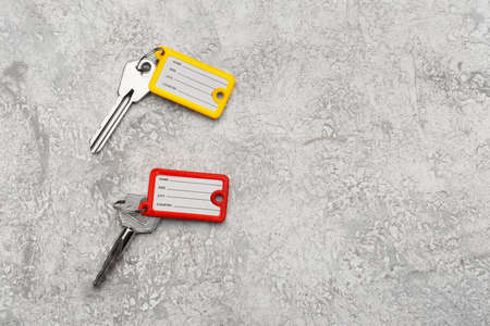 Keys with colorful plastic tags on grunge backgroundの写真素材
