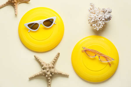 flying disks, sunglasses, coral and starfish on color backgroundの写真素材