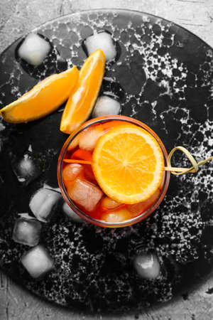 Glass of Aperol spritz cocktail on grunge backgroundの写真素材
