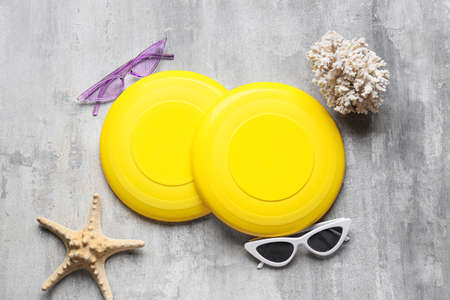 Flying disks, sunglasses, starfish and coral on grunge backgroundの写真素材