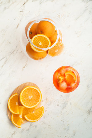 Glass of Aperol spritz cocktail on light backgroundの写真素材