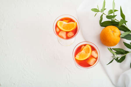 Glasses of Aperol spritz cocktail on light background