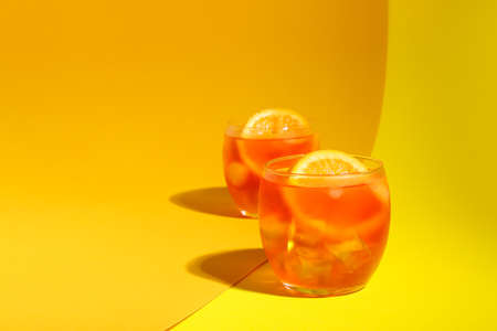 Glasses of Aperol spritz cocktail on color backgroundの写真素材