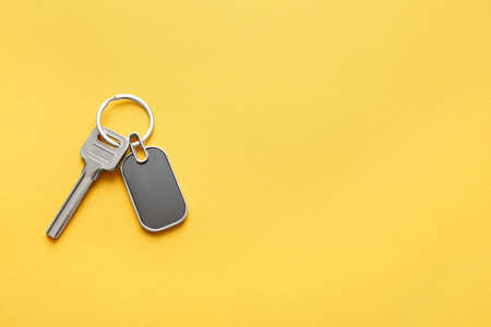 Key with stylish keychain on color backgroundの写真素材
