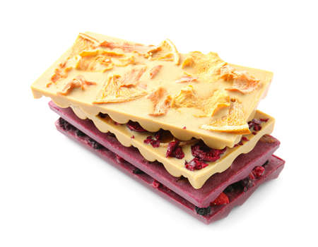 Handmade chocolate bars with fruits and berries on white background