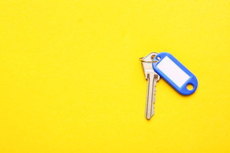 Plastic tag with key on color backgroundの写真素材