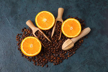 Composition with coffee beans and fresh oranges on dark backgroundの写真素材