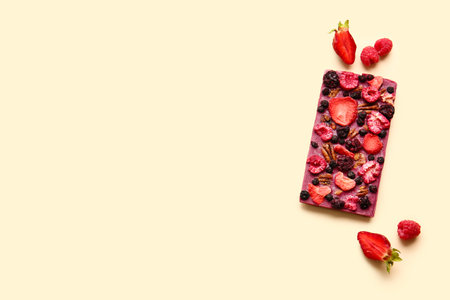 Handmade chocolate bar with fruits, berries and nuts on color backgroundの写真素材