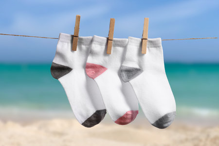 Rope with clean socks outdoors at sea resortの写真素材