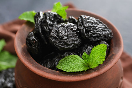 Bowl with tasty prunes on table, closeupの写真素材