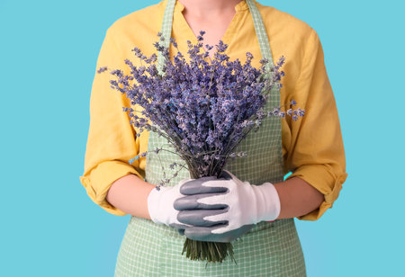 Female gardener with lavender on color backgroundの写真素材