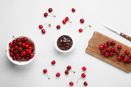 Composition with ripe cherry and jam on white backgroundの写真素材