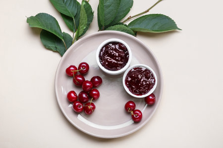 Composition with tasty cherry jam on color backgroundの写真素材