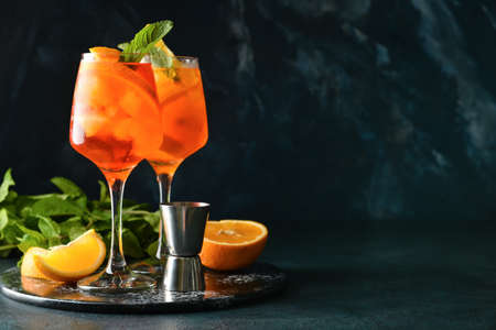 Glasses of tasty aperol spritz cocktail on dark backgroundの写真素材