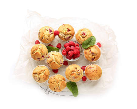 Grid with tasty raspberry muffins on white backgroundの写真素材