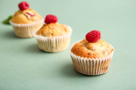 Tasty raspberry muffins on color background, closeupの写真素材