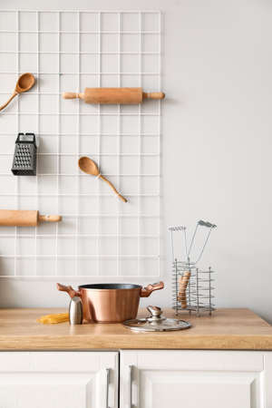 Copper cooking pot with saltcellar on counter in kitchen