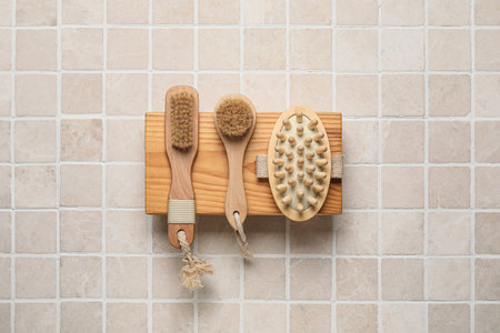 Wooden board with different body brushes on light tile backgroundの写真素材