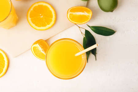 Glass of tasty orange juice on light background, closeupの写真素材