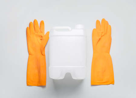 Plastic canister and rubber gloves on light backgroundの写真素材