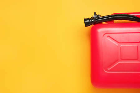 Plastic canister with rubber nozzle on color background