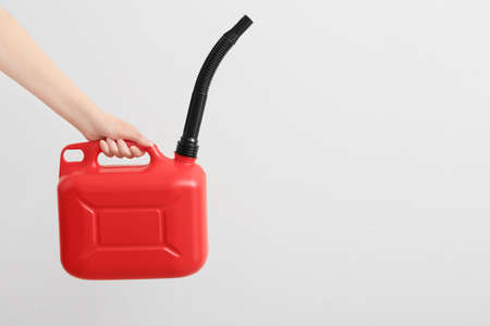 Woman holding canister rubber nozzle on light backgroundの写真素材