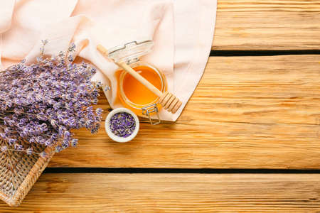 Composition with lavender flowers and honey on wooden background, closeupの写真素材